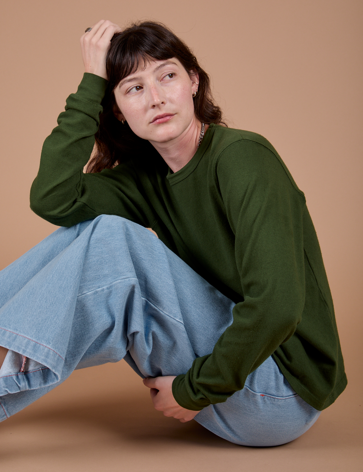 Side view of Long Sleeve Burly Tee in Evergreen on Alex