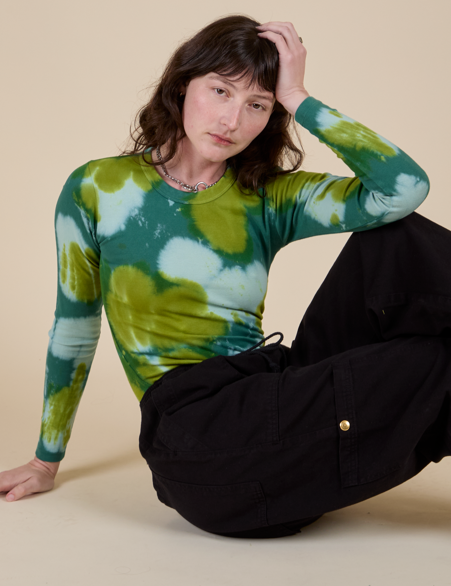 Long Sleeve Baby Tee in Green Magic Waters and black Drop Pocket Cargo Pants on Alex