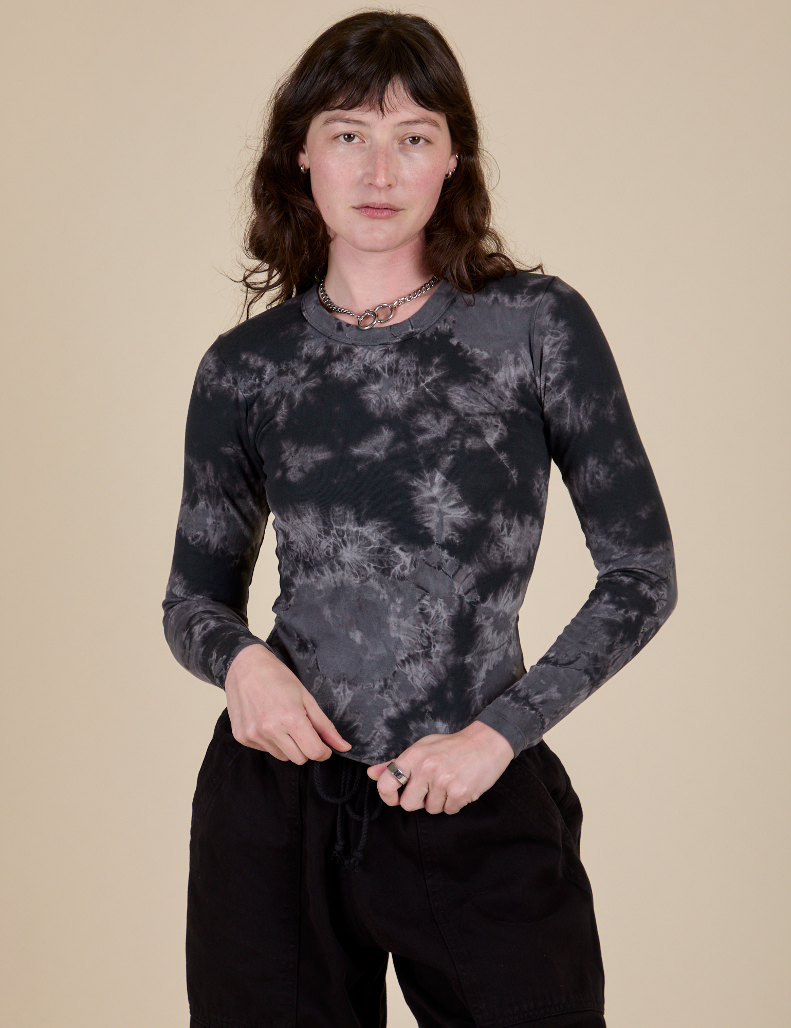 Alex is 5’8” and wearing P Long Sleeve Baby Tee in Black Magic Waters