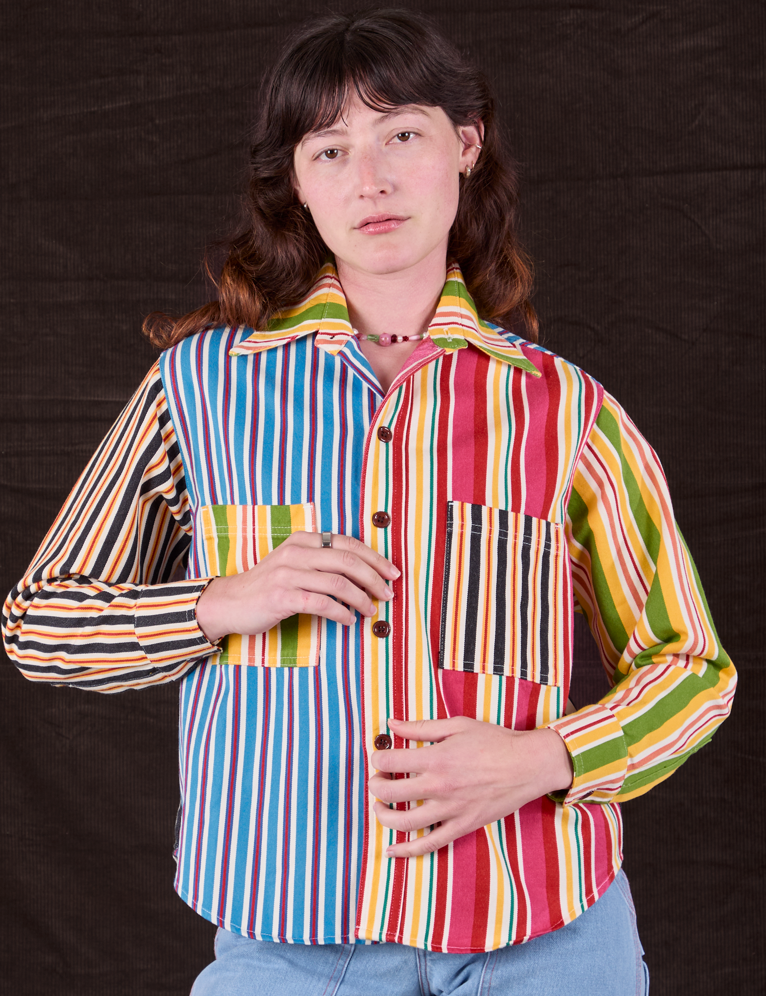 Alex is wearing a buttoned up Cropped Overshirt in Mixed Stripe