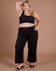 Juliet is 5’7” and wearing 1XL Action Pants in Basic Black paired with black Mini tank