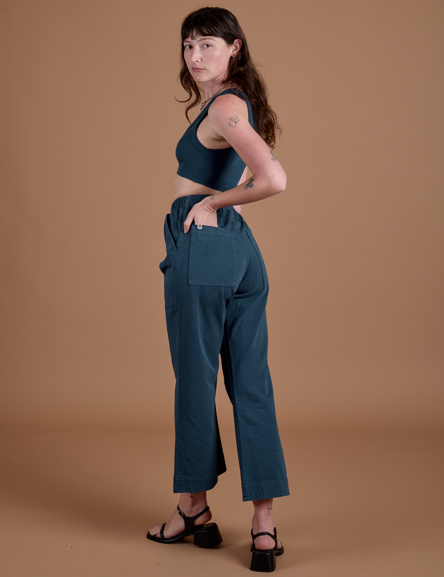 Action Pants in Lagoon angled back view on Alex