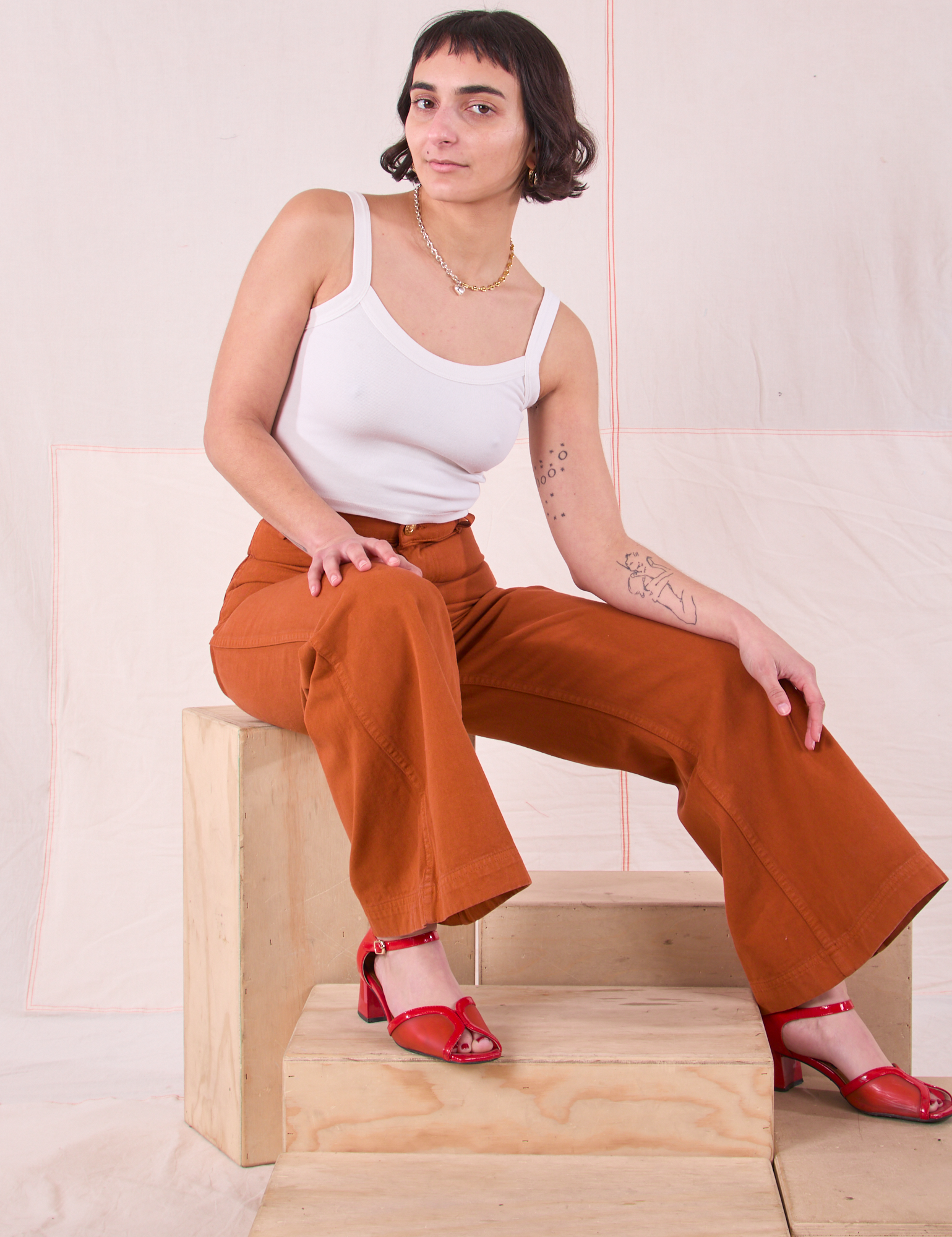 Soraya is wearing Bell Bottoms in Burnt Terracotta and Cami in vintage tee off-white