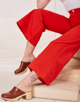 Bell Bottoms in Mustang Red pant leg close up on Alex
