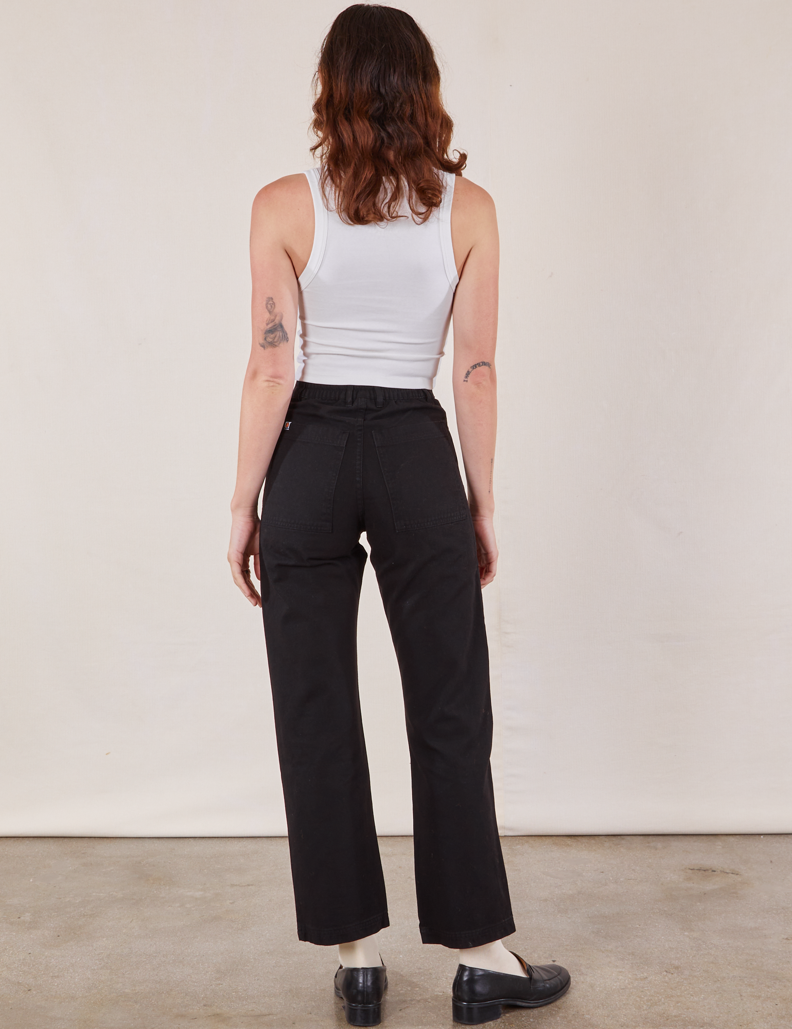 Back view of Work Pants in Black and Cropped Tank in vintage tee off-white on Alex