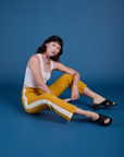 Painted Work Pants in Mustard Yellow and vintage tee white Cropped Tank on Alex