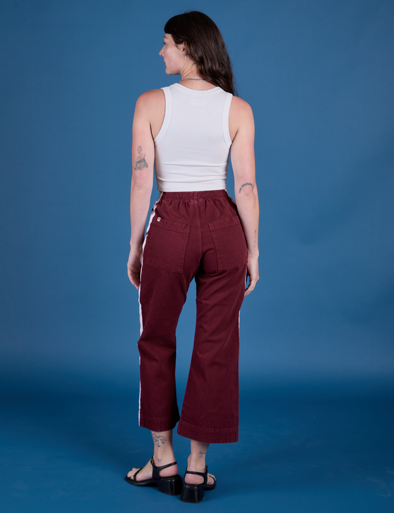Back view of Painted Action Pants in Red Wine and vintage tee white Cropped Tank