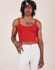 Jerrod is 6'3" and wearing S Cropped Cami in Mustang Red paired with vintage off-white Western Pants