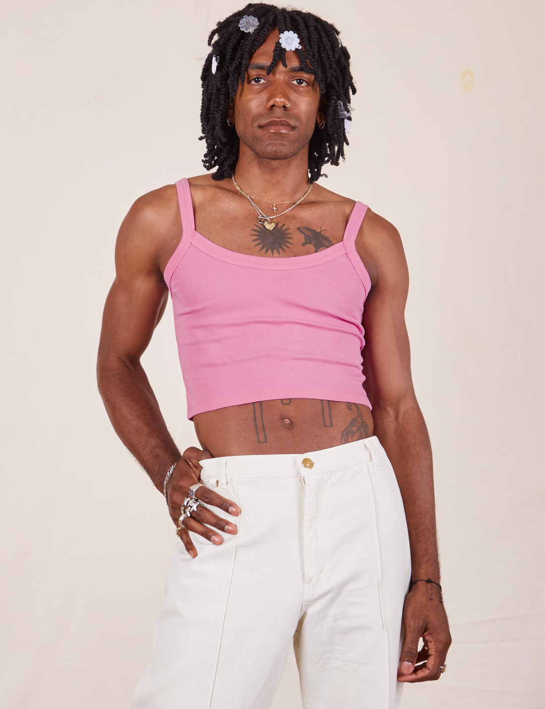 Jerrod is 6'3" and wearing S Cropped Cami in Bubblegum Pink paired with vintage off-white Western Pants