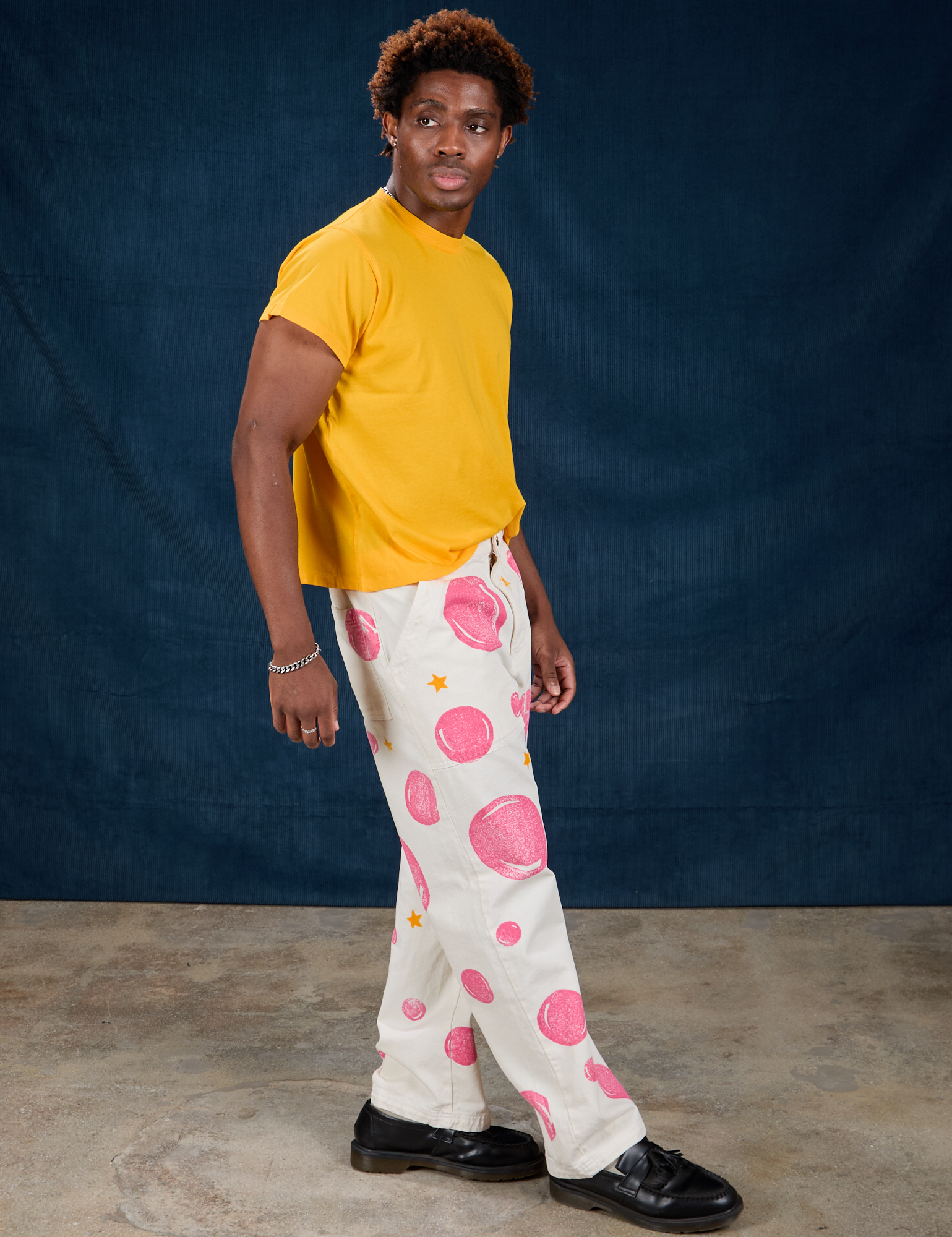 Side view of Paintstamped Work Pants in Bubblegum and sunshine yellow Organic Vintage Tee