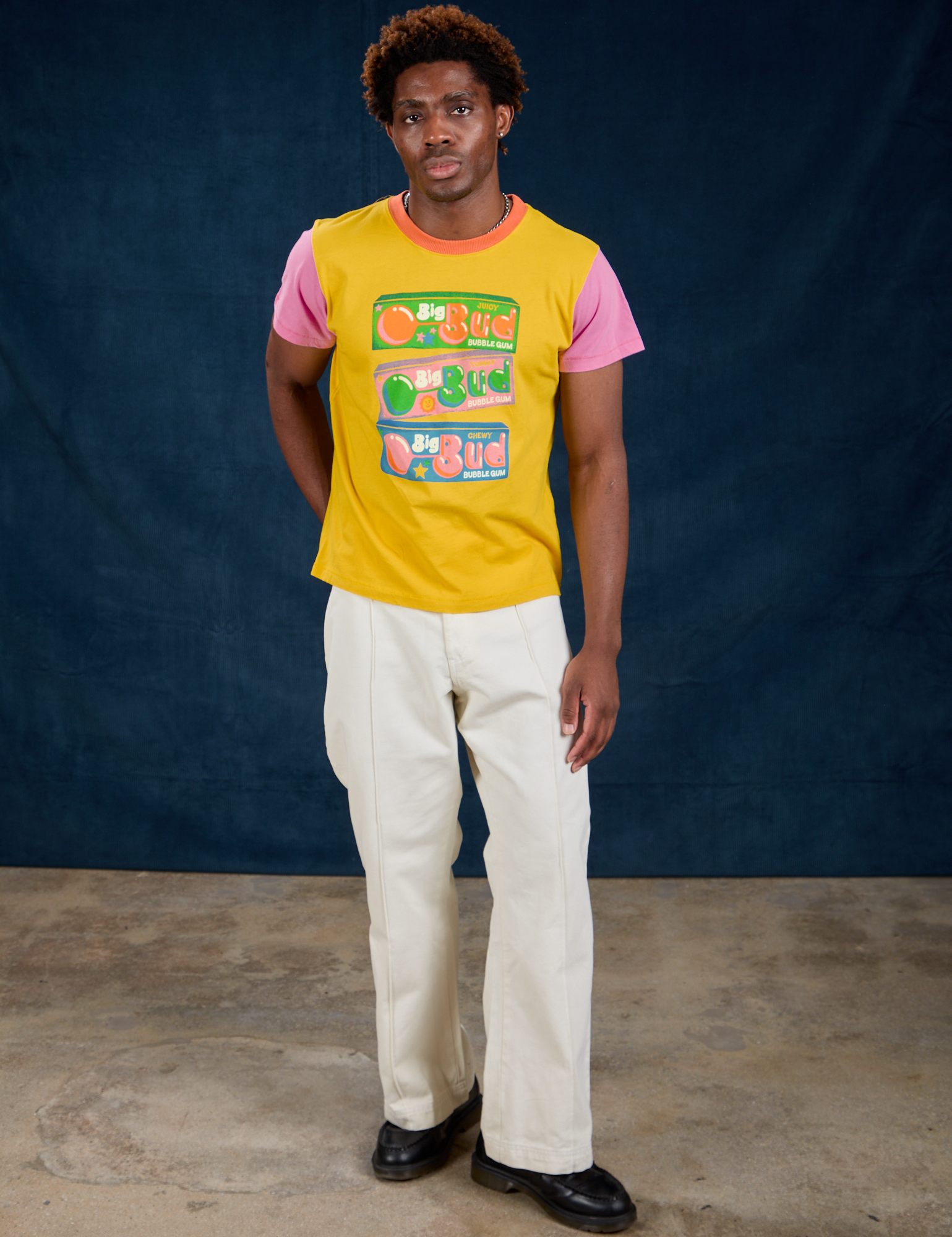 Isaac is wearing Vintage Tee in Bubblegum and Western Pants in Vintage Tee Off-White