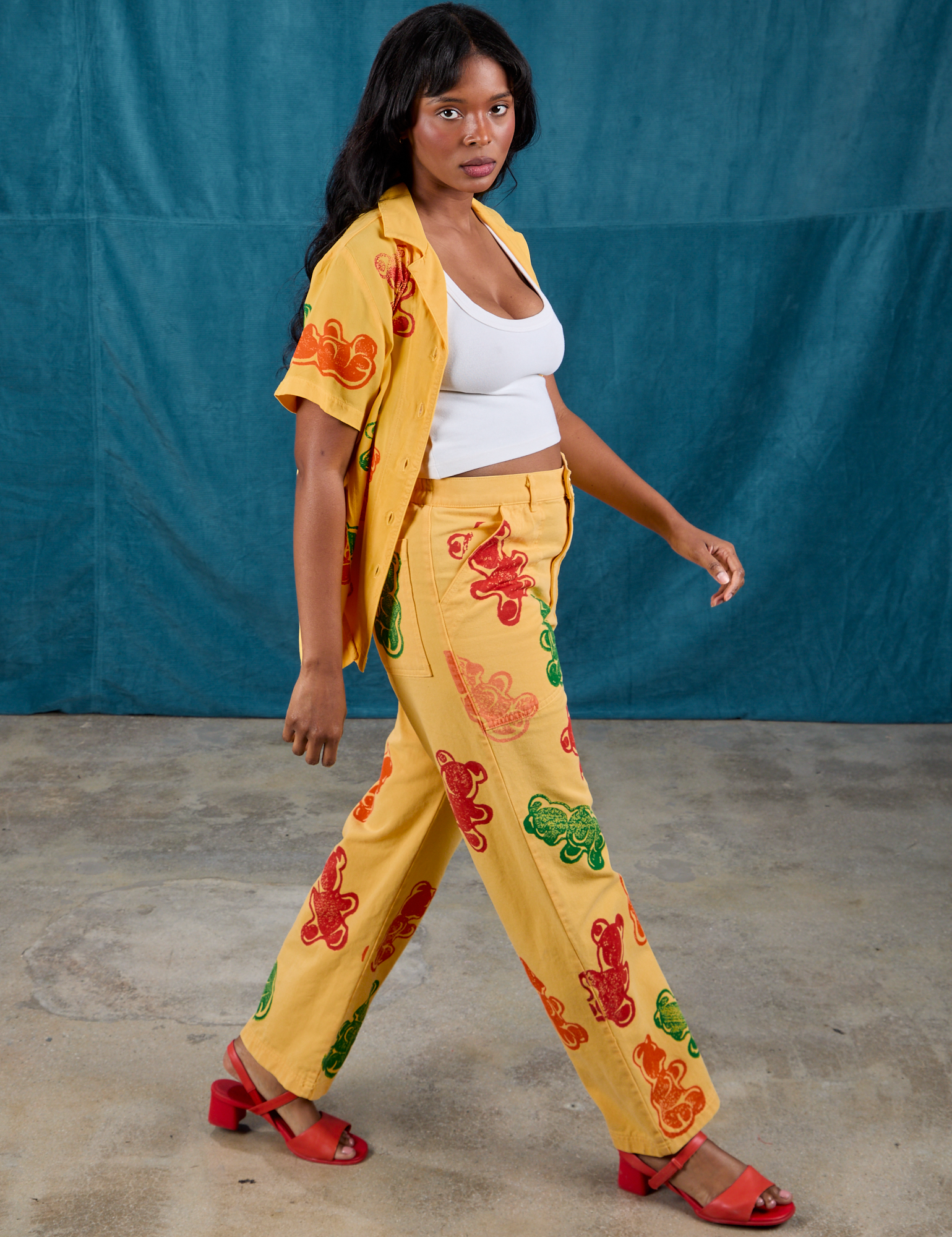 Side view of Gummy Bear Paintstamped Work Pants in Butter Yellow and matching Pantry Button-Up on Kandia