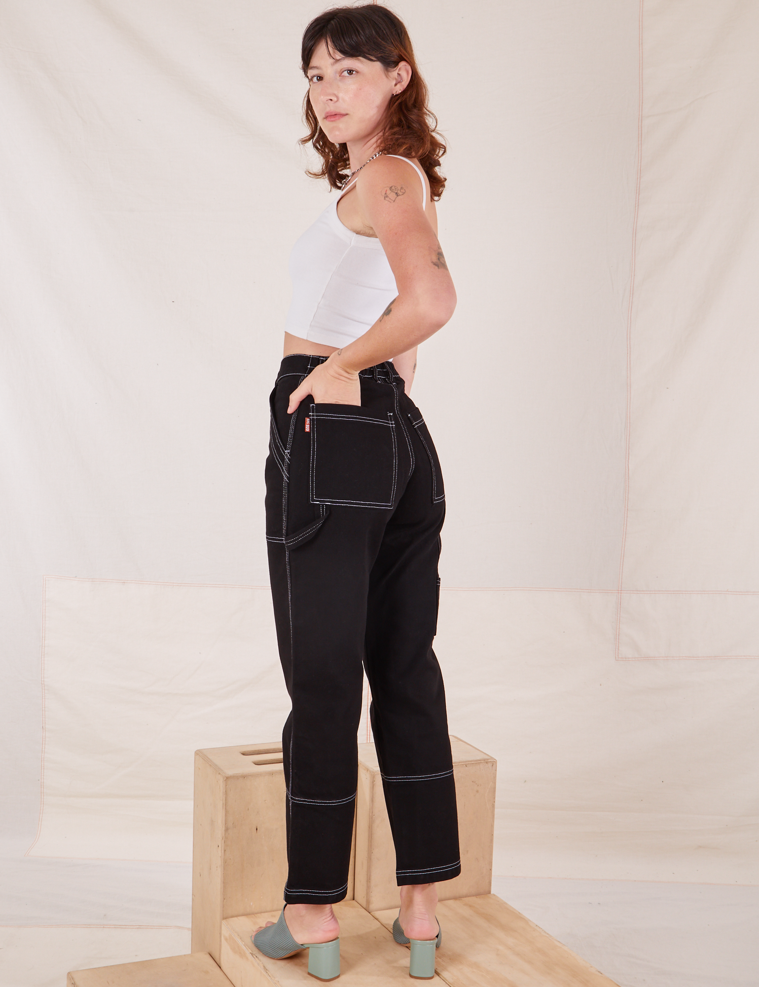 Angled back view of Carpenter Jeans in Black worn by Alex