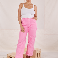 Tiara is 5'4" and wearing S Carpenter Jeans in Bubblegum Pink paired with a vintage off-white Cami