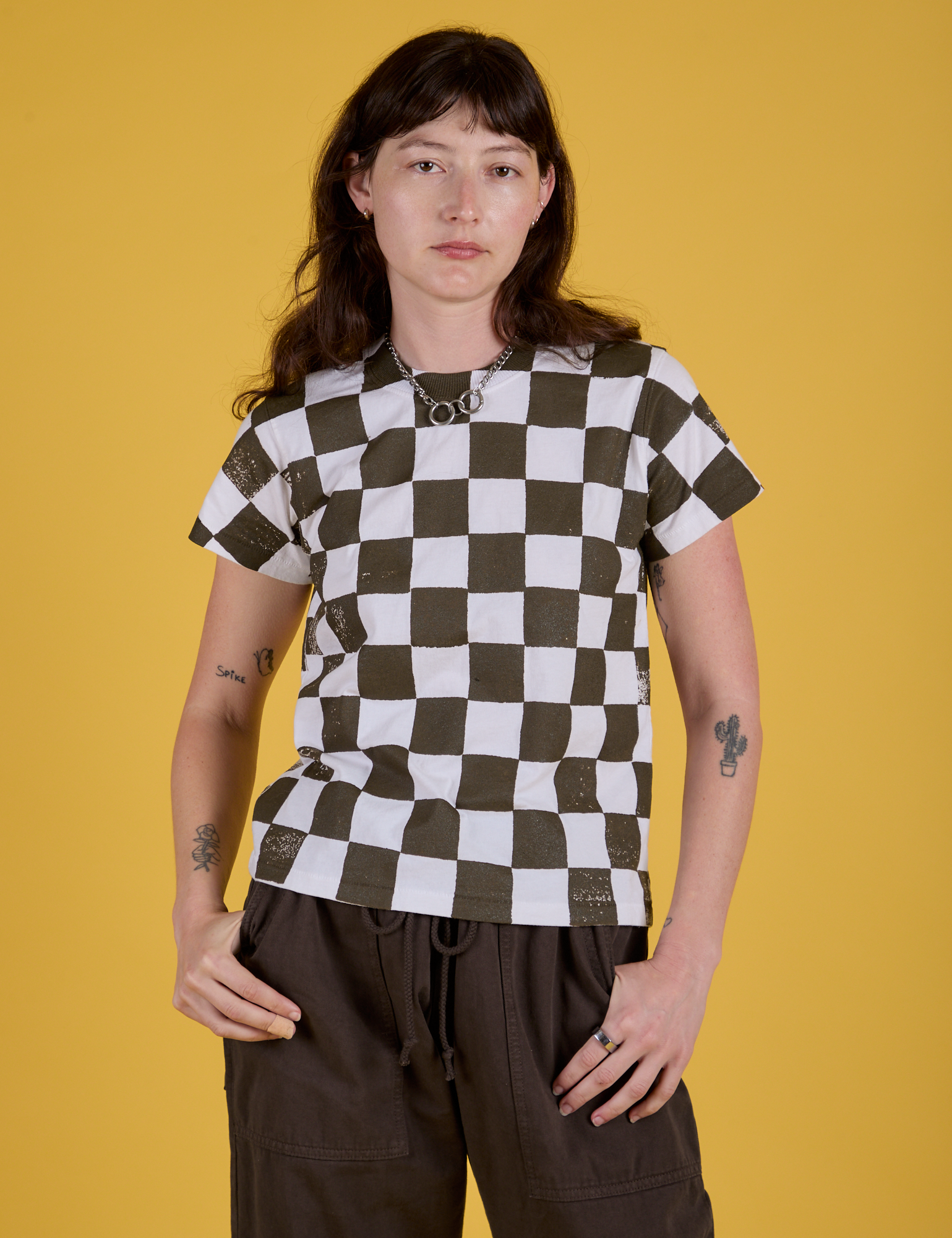 Alex is 5'8" and wearing P Checker Organic Tee in Espresso Brown