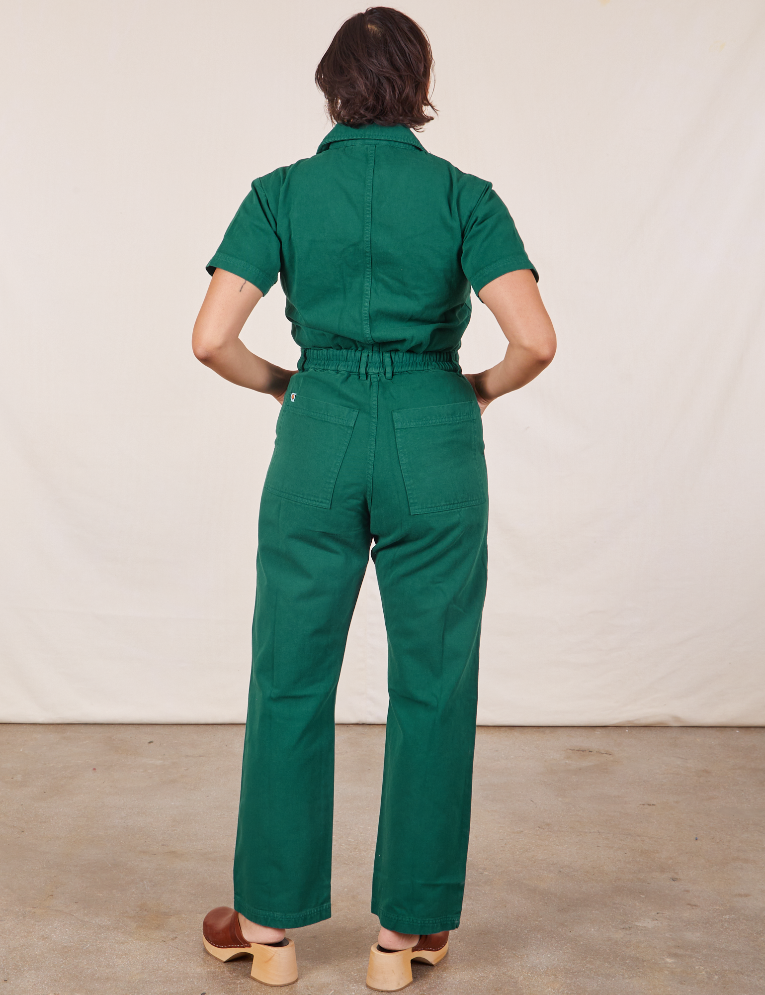 Back view of Short Sleeve Jumpsuit in Hunter Green worn by Tiara