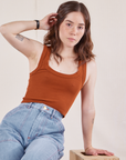 Hana is wearing Cropped Tank Top in Burnt Terracotta and light wash Carpenter Jeans