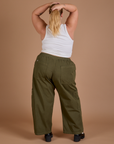 Back view of Drop Pocket Cargo Pants in Surplus Green and Cropped Tank in Vintage Tee White