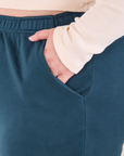 Easy Pants in Lagoon front pocket close up. Ashley has her hand in the pocket.