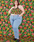 Marielena is wearing Halter Top in Flower Tangle and light wash Carpenter Jeans