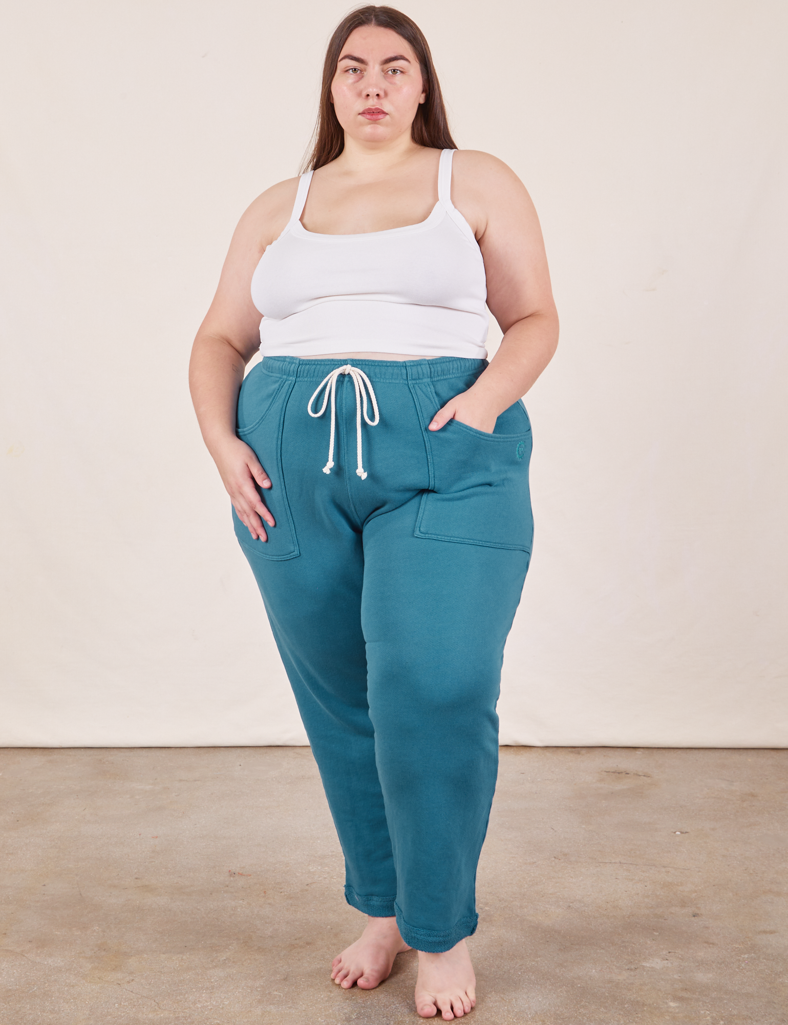Marielena is 5&#39;8&quot; and wearing 2XL Cropped Rolled Cuff Sweatpants in Marine Blue paired with vintage off-white Cami
