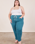 Marielena is 5'8" and wearing 2XL Cropped Rolled Cuff Sweatpants in Marine Blue paired with vintage off-white Cami