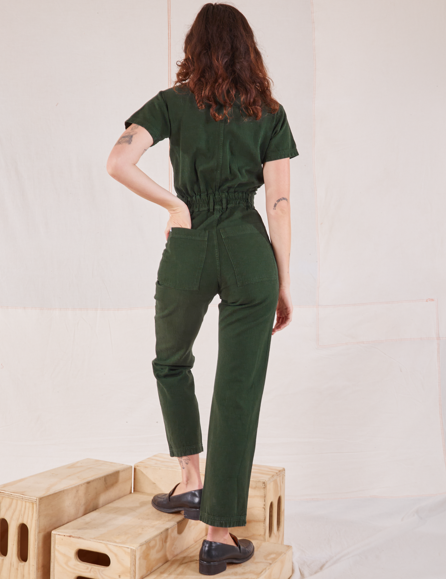 Heritage Short Sleeve Jumpsuit in Swamp Green back view on Alex