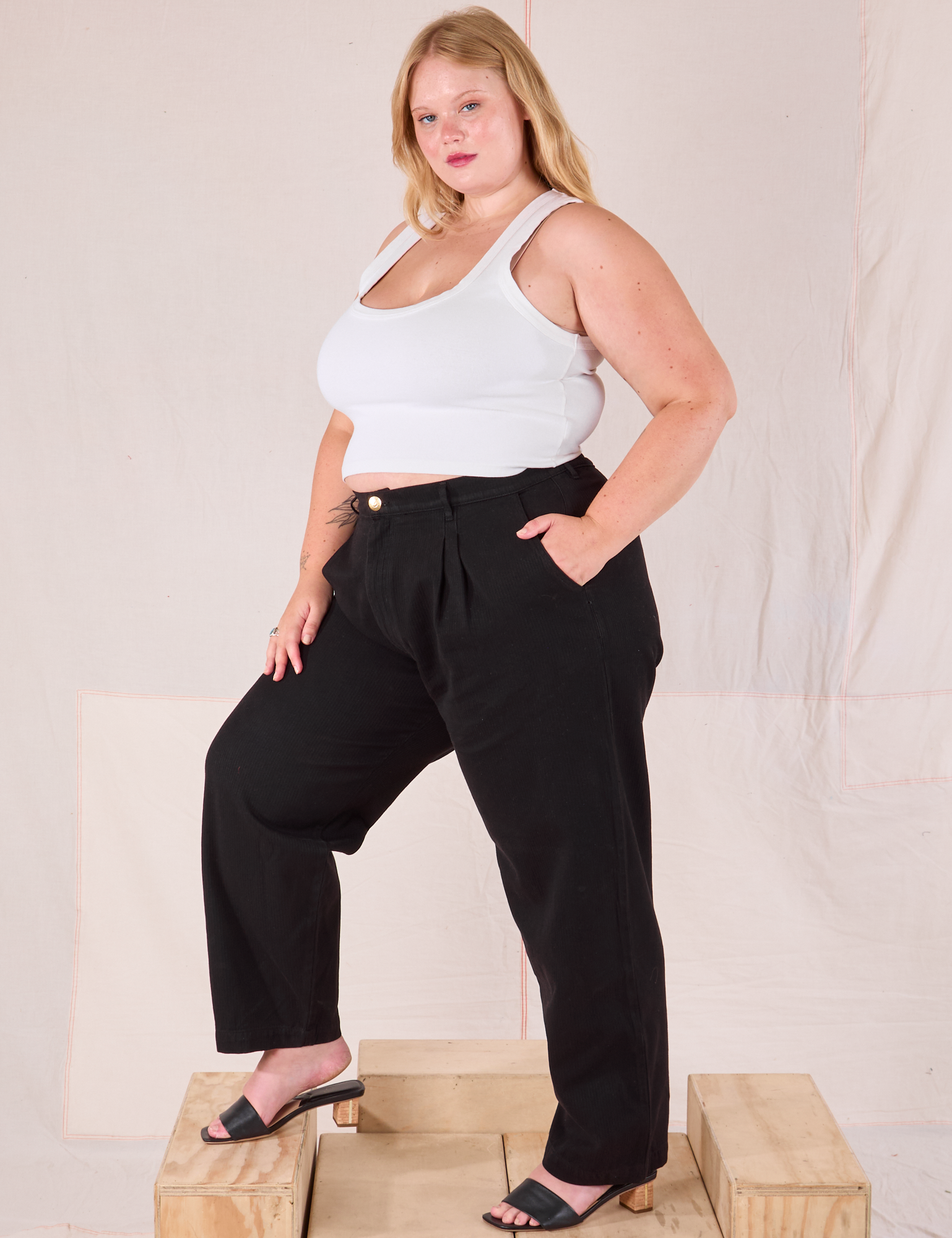 Angled front view of Heritage Trousers in Basic Black and Cropped Tank in vintage tee off-white