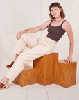Alex is wearing Heritage Trousers in Vintage Off-White and espresso brown Cropped Cami