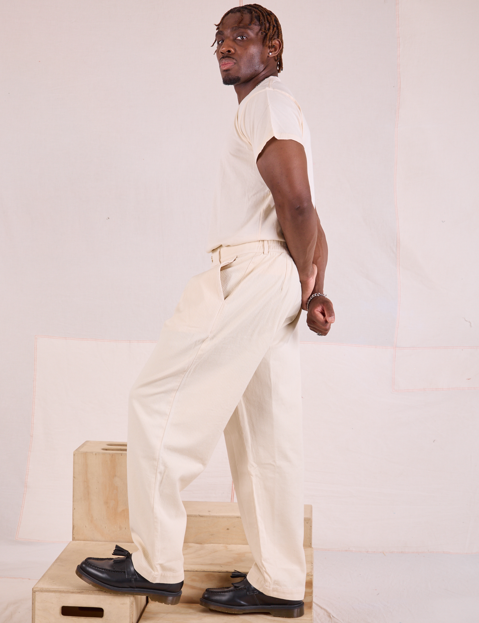 Side view of Heritage Trousers in Natural and Organic Vintage Tee in vintage tee off-white