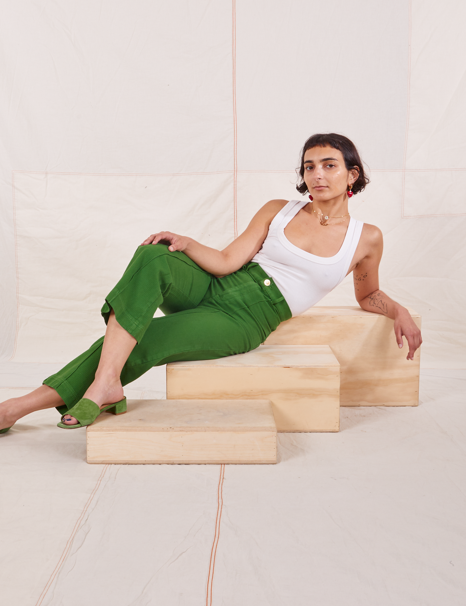 Soraya is wearing Heritage Westerns in Lawn Green and Cropped Tank Top in vintage tee off-white