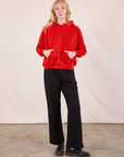 Margaret is wearing Oversized Hoodie in Mustang Red and black Western Pants