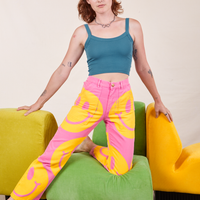 Alex is wearing Icon Work Pants in Smilies and marine blue Cropped Cami.