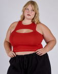 Juliet is 5’7” and wearing L Porthole Tank in Mustang red
