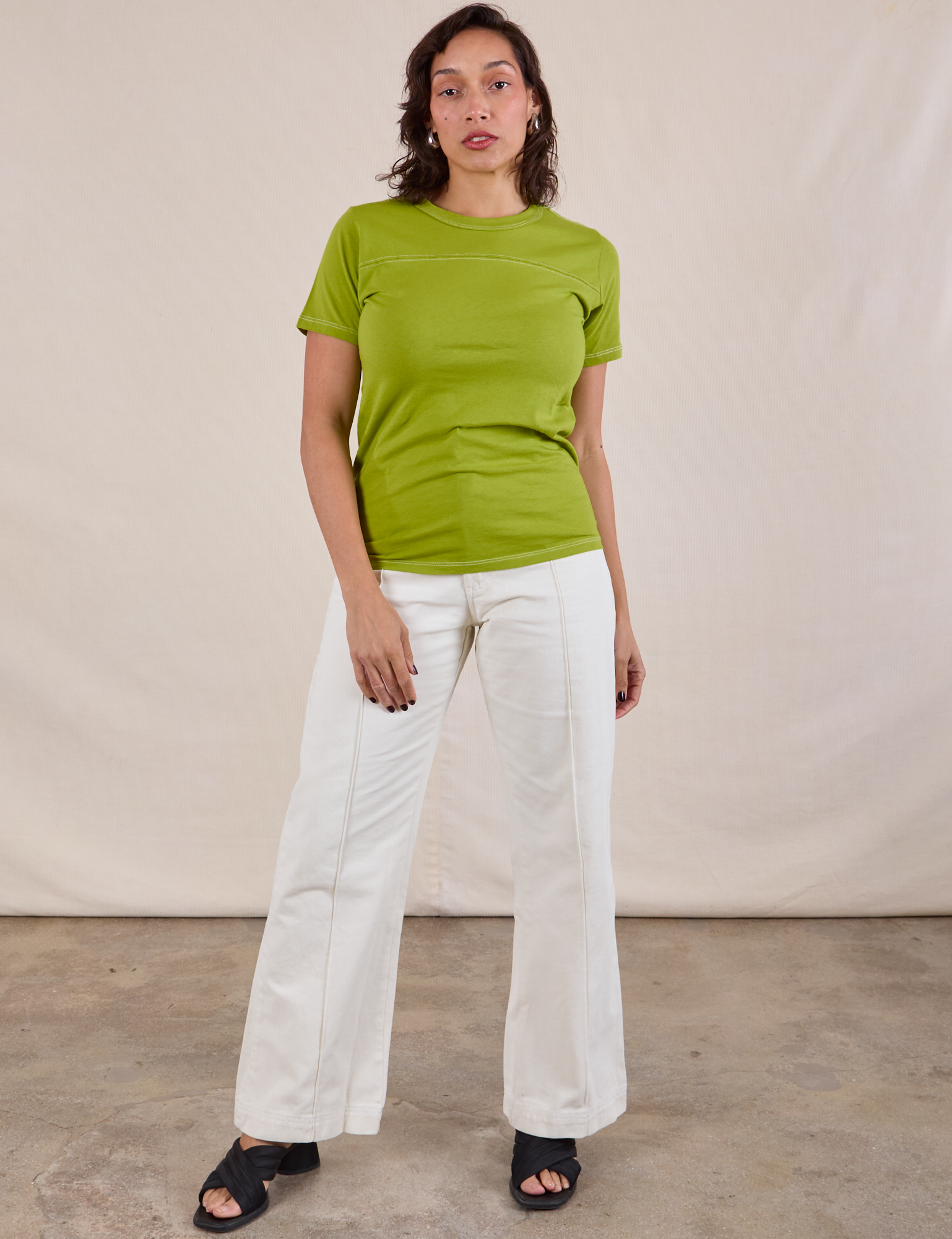 Tiara is wearing JV Tee in Gross Green and vintage tee off-white Western Pants