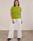 Tiara is wearing JV Tee in Gross Green and vintage tee off-white Western Pants