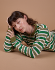 Alex is wearing Long Sleeve Striped Burly Tee in Green