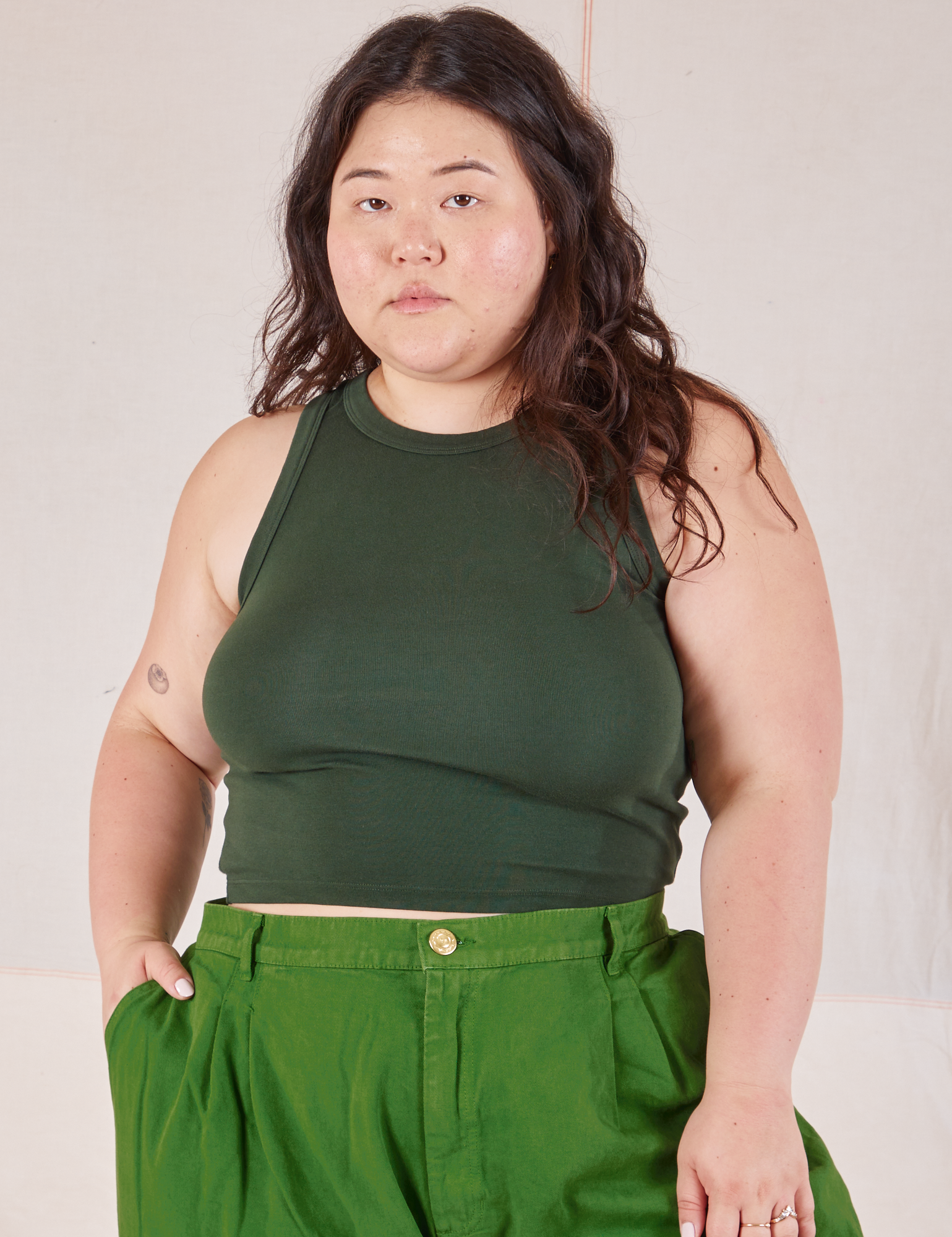 Ashley is 5’7” and wearing XL Racerback Tank in Swamp Green