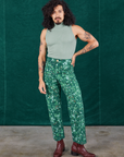 Jesse is 5'8" and wearing XS Marble Splatter Work Pants in Hunter Green paired with sage green Sleeveless Turtleneck