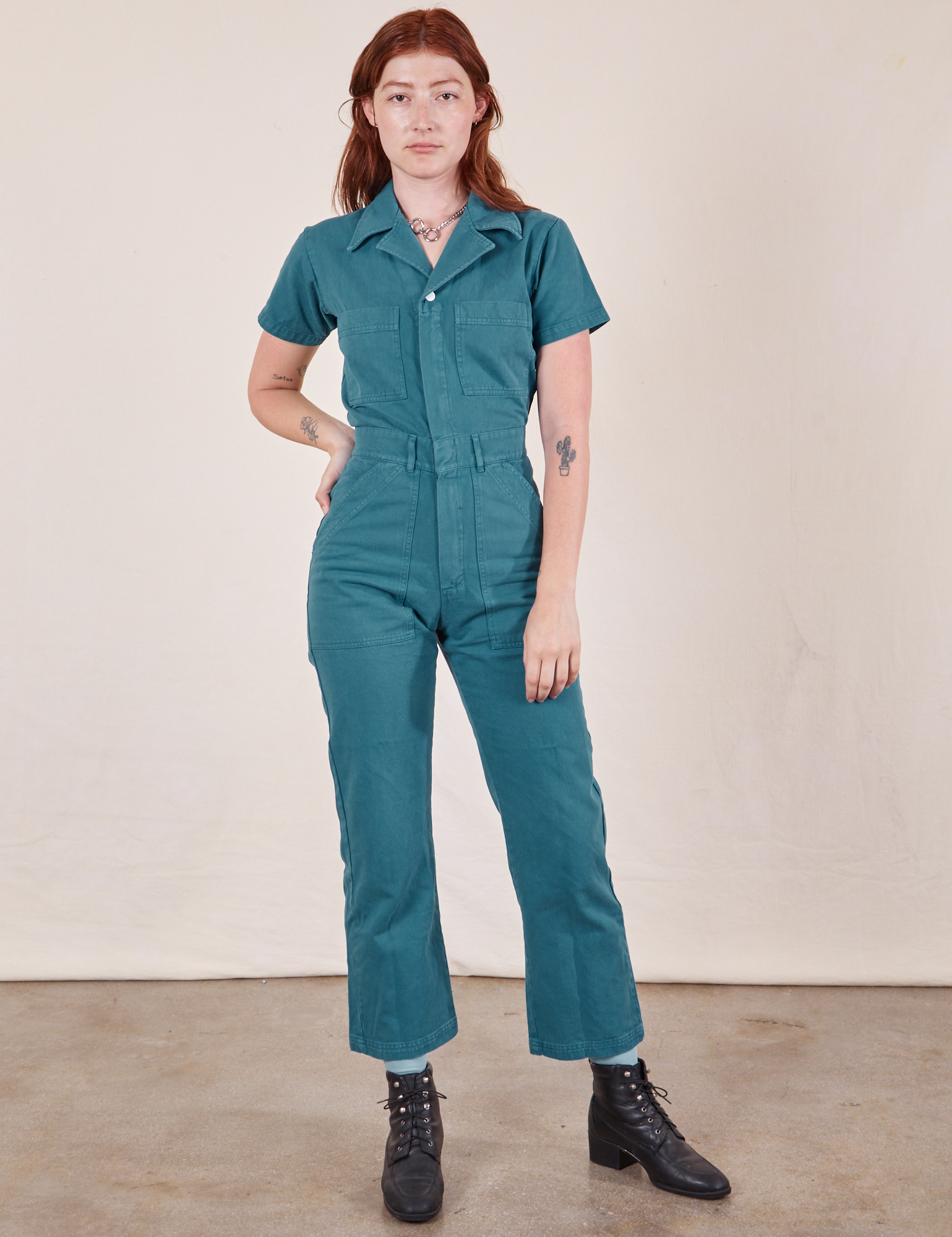 Alex is wearing Short Sleeve Jumpsuit in Marine Blue