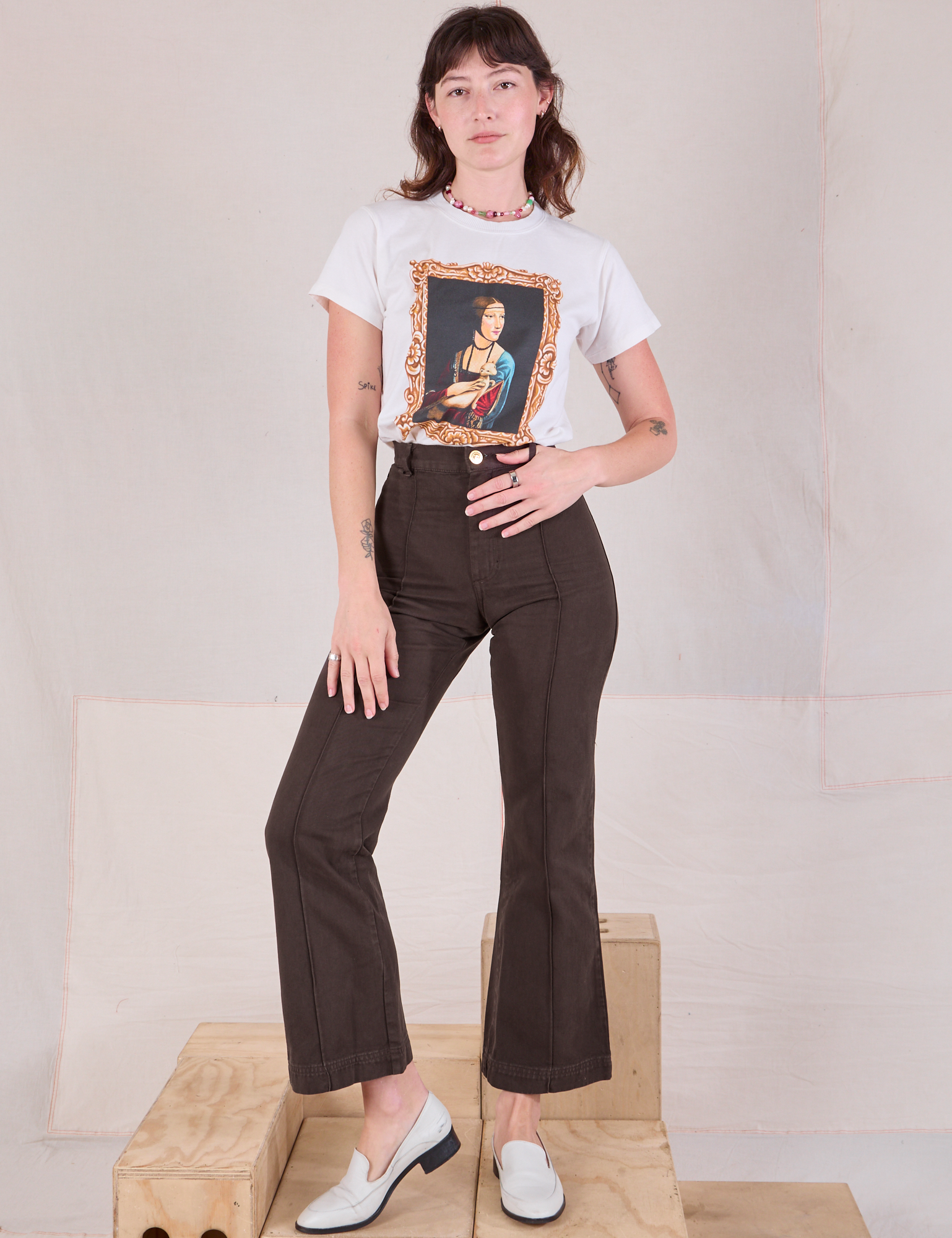 Alex is wearing Masters Organic Tee in Lady With An Ermine tucked into espresso brown Western Pants