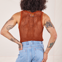 Back view of Mesh Tank Top in Burnt Terracotta and light wash Sailor Jeans worn by Jesse