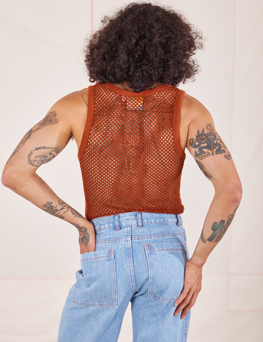 Back view of Mesh Tank Top in Burnt Terracotta and light wash Sailor Jeans worn by Jesse