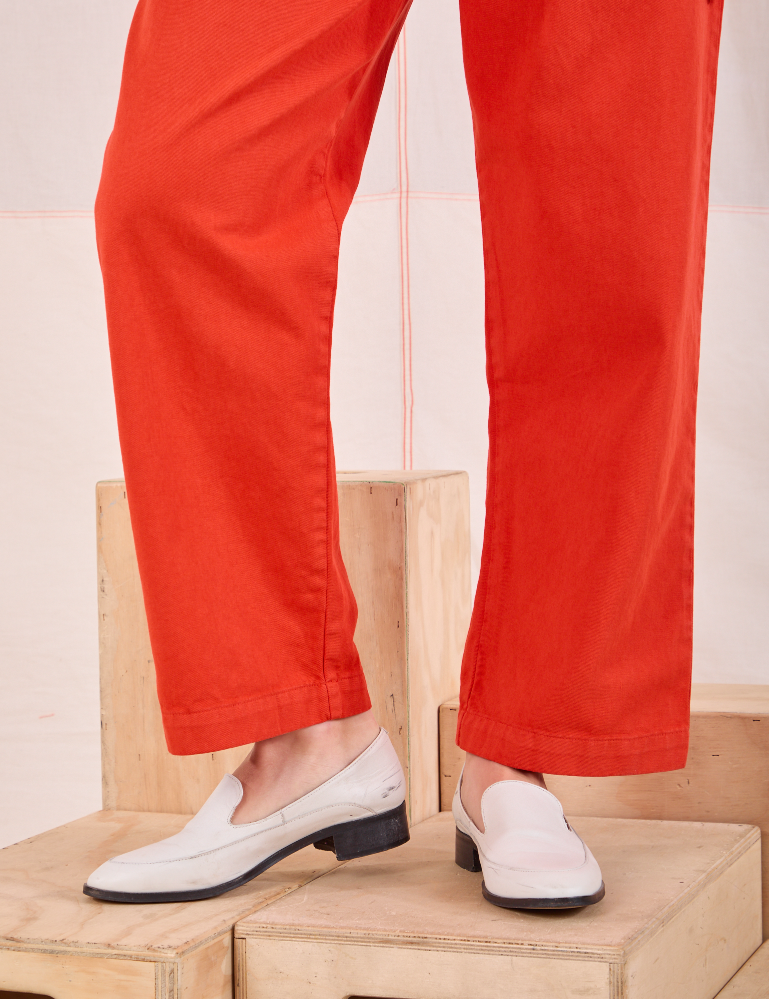 Mid-Rise Pleated Trousers in Chili Red pant leg close up on Alex