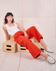 Alex is wearing Mid-Rise Pleated Trousers in Chili Red and Cropped Tank in vintage tee off-white