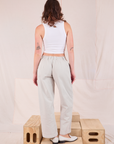 Back view of Mid-Rise Pleated Trousers in Stone White and Cropped Tank in vintage tee off-white on Alex