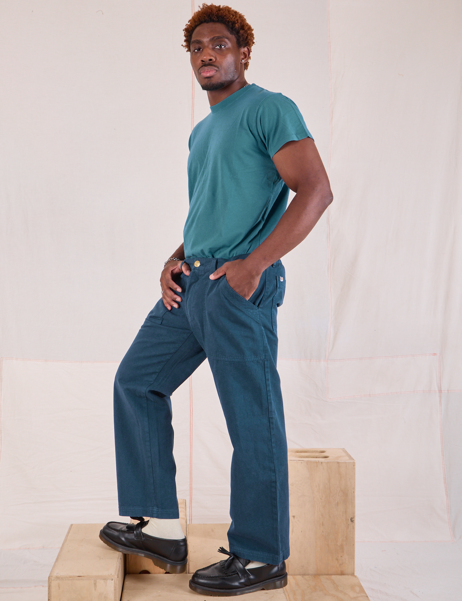 Side view of Mid-Rise Work Pants in Lagoon and marine blue Organic Vintage Tee on Issac