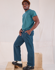 Side view of Mid-Rise Work Pants in Lagoon and marine blue Organic Vintage Tee on Issac