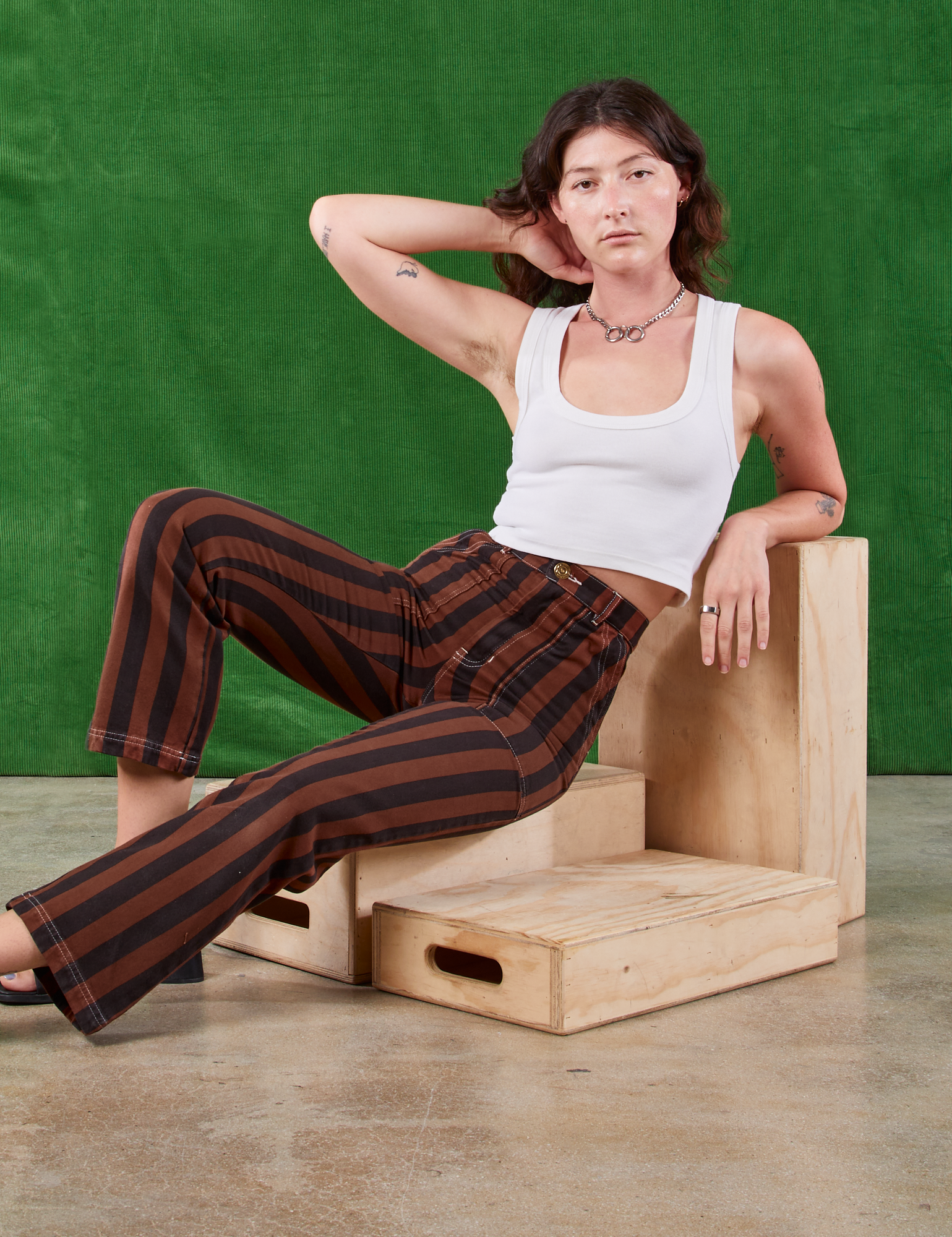 Alex is wearing Black Stripe Work Pants in Fudgesicle Brown and Cropped Tank in vintage tee off-white