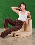 Alex is wearing Black Stripe Work Pants in Fudgesicle Brown and Cropped Tank in vintage tee off-white